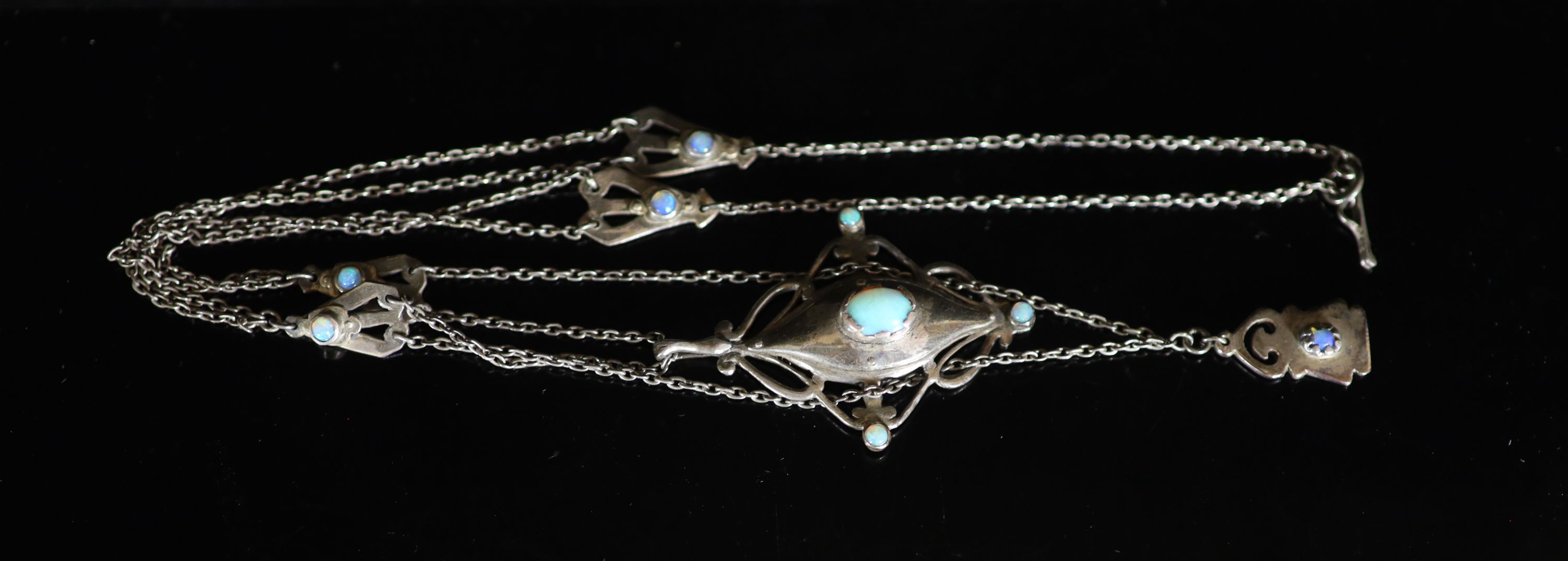 An early 20th century Arts & Crafts silver and nine stone cabochon black opal set drop pendant necklace